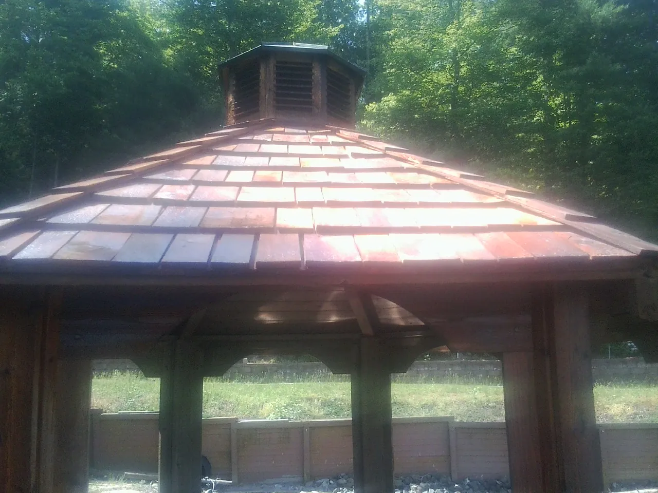 New cedar shake roof and cupola on a lakeside gazebo in Platteville